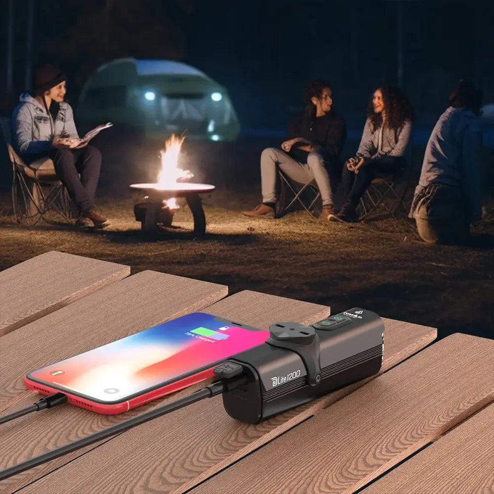 The TOWILD Dlite1200 bike light being used as a power bank to charge a smartphone via its USB-C port.